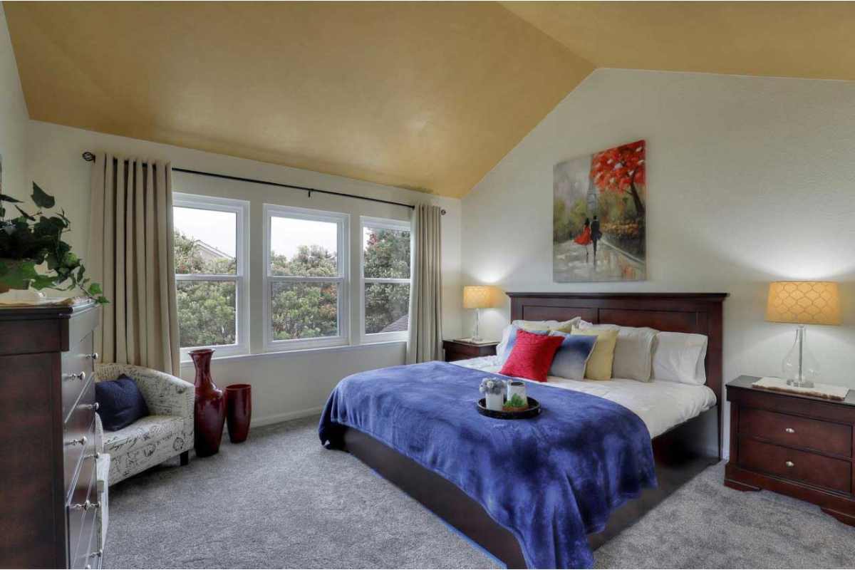 Interior bedroom with yellow ceiling designed by Deja Blue Home Staging and Design near Redwood (CA)