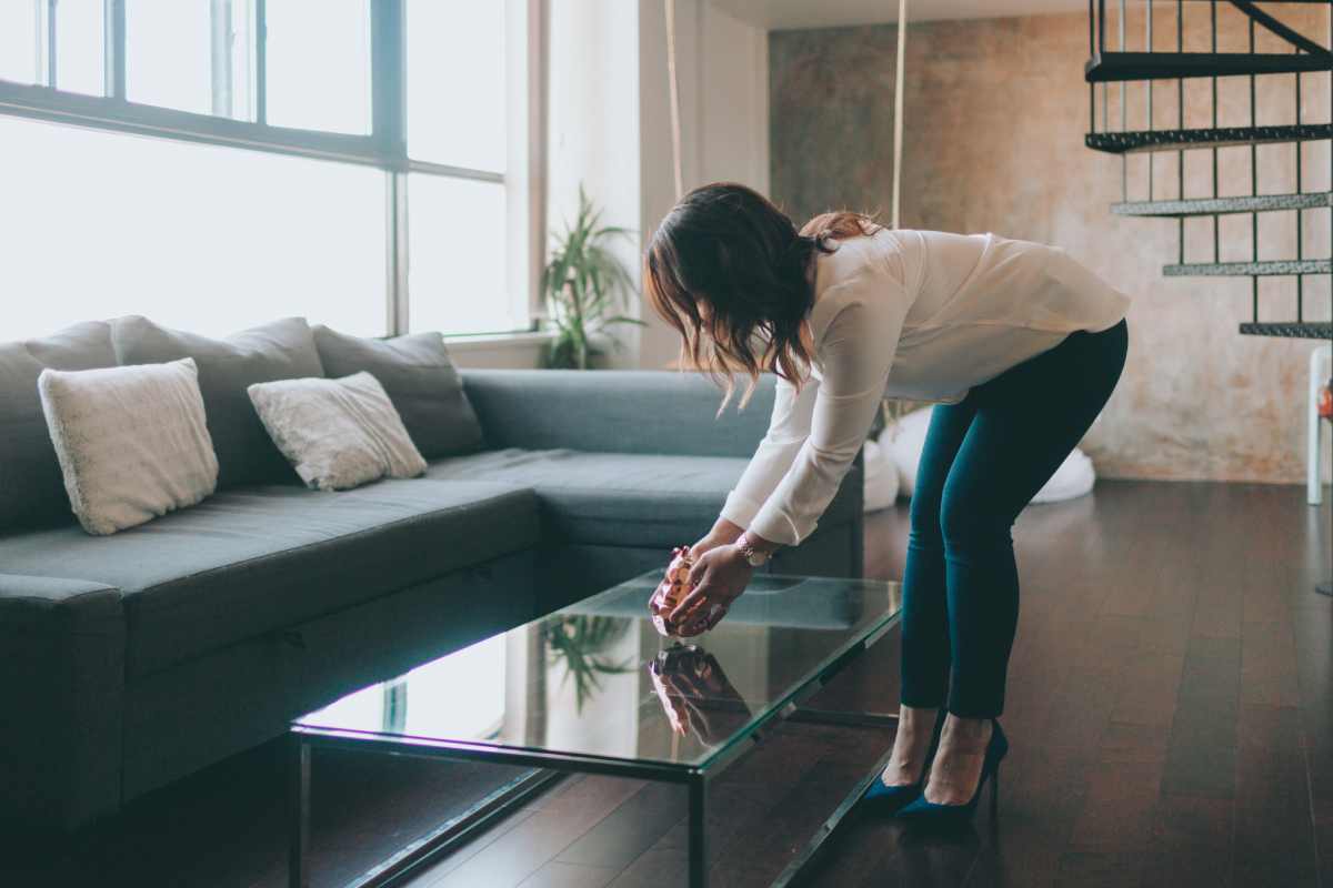 Interior Designer placing a vase on a coffee table in a living room