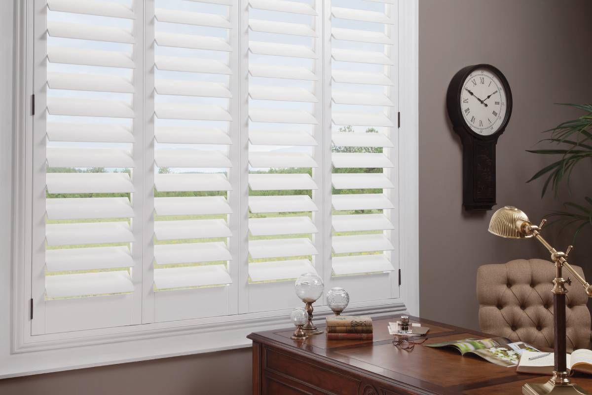 A Study outfitted with white Hunter Douglas NewStyle® Hyrbid Shutters